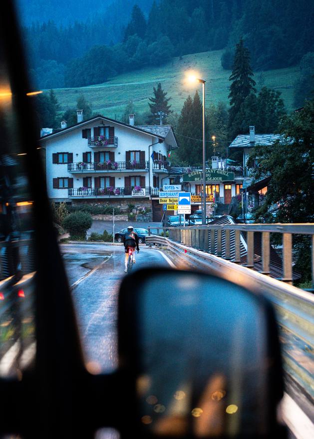 Victoria Stansfield riding at night in the rain, seen in a wing mirror